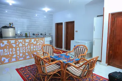 a kitchen with a table and chairs in a kitchen at Jamaica Guest House in Aswan