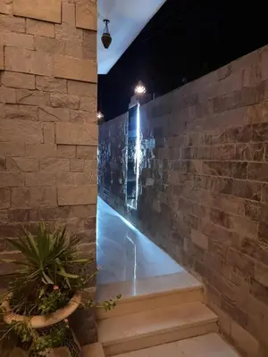 a stone wall and stairs at night at Nile diana luxor in Luxor