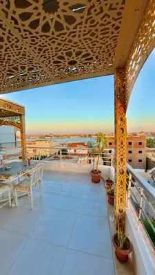 a balcony with a table and chairs on a building at Nile diana luxor in Luxor