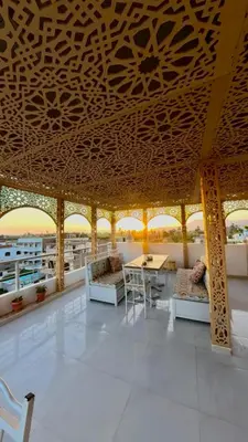 a room with a table and chairs and windows at Nile diana luxor in Luxor