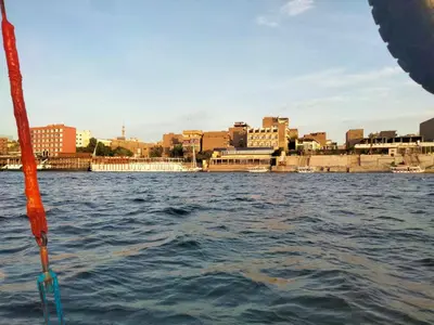 a view of a city from a boat in the water at Nile queen Apartments for Rent in Luxor