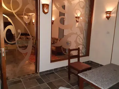 a table and a chair next to a window at German Dolphin in Quseir