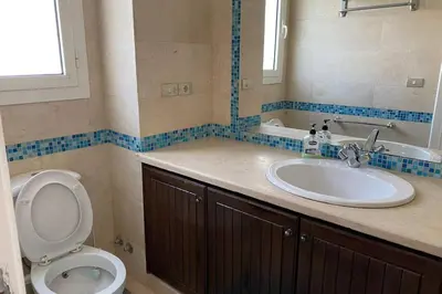a bathroom with a toilet and a sink at Luxury 4 bedroom villa with a heated pool in Hurghada