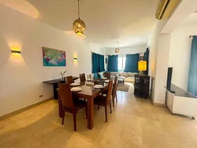 a dining room with a table and chairs at Luxury 4 bedroom villa with a heated pool in Hurghada