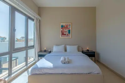 a bedroom with a bed and a large window at Long Island Gouna 5BR Tawila Beach House & Pool in Hurghada