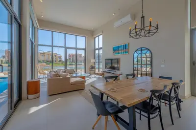 a dining room and living room with a table and chairs at Long Island Gouna 5BR Tawila Beach House & Pool in Hurghada