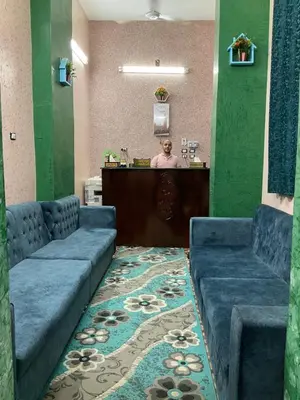 a waiting room with two blue couches and a bar at ALRahman Building in Aswan