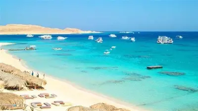 a beach with a bunch of boats in the water at sheraton blaza 101 in Hurghada