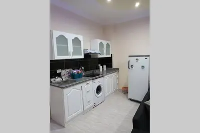 a kitchen with a washing machine and a refrigerator at sheraton blaza 101 in Hurghada