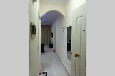 a hallway with white walls and an arched doorway at sheraton blaza 101 in Hurghada