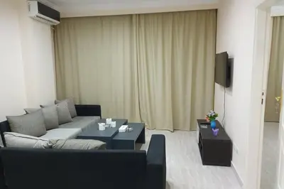 a living room with a couch and two tables at sheraton blaza 101 in Hurghada