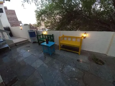 a patio with two benches and a table with lights at Private House with Garden and terrace in Aswan in Aswan