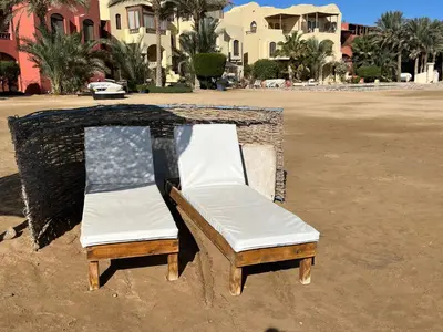 a couple of chairs sitting on a dirt field at El Gouna, Red Sea, Egypt, West Golf 2 Bedroom Flat in Hurghada
