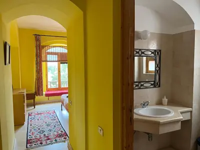 a yellow bathroom with a sink and a mirror at El Gouna, Red Sea, Egypt, West Golf 2 Bedroom Flat in Hurghada