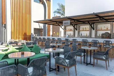 a patio with tables and chairs and a bar at Sunrise Tucana Resort Grand Select in Hurghada