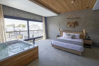 a bedroom with a bed and a bath tub at Sunrise Tucana Resort Grand Select in Hurghada