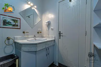 a bathroom with a sink and a phone at Turtles Beach Resort Hurghada By VTGooo in Hurghada