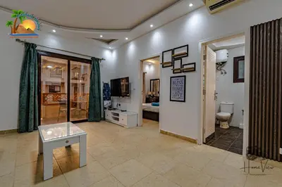 a living room with a toilet and a television at Turtles Beach Resort Hurghada By VTGooo in Hurghada