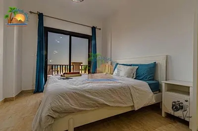 a bedroom with a large bed and a window at Turtles Beach Resort Hurghada By VTGooo in Hurghada