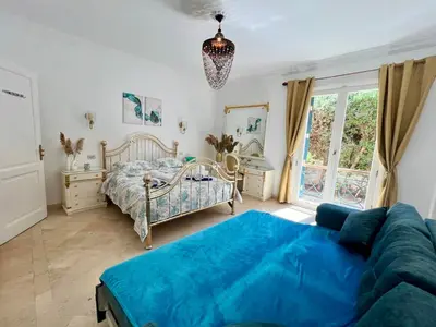 a living room with a bed and a couch at Hill Villa Venezia El Gouna: pool, beach & WiFi in Hurghada