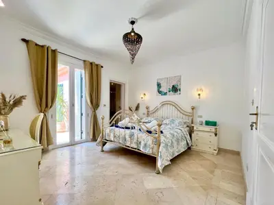 a bedroom with a bed and a dresser at Hill Villa Venezia El Gouna: pool, beach & WiFi in Hurghada