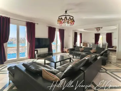 a large living room with couches and a chandelier at Hill Villa Venezia El Gouna: pool, beach & WiFi in Hurghada