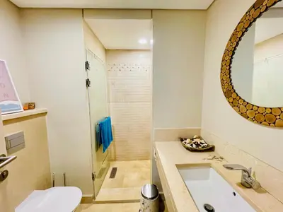 a bathroom with a toilet and a sink at Kitesurfer Shared House, Pool View & Beach Access in Hurghada
