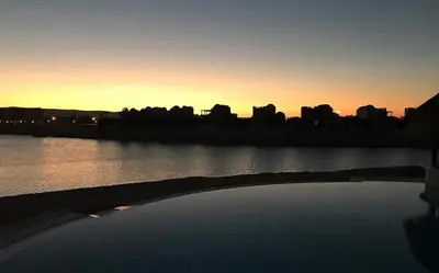 a bridge over a river with a city in the background at Y 140 wast golf heated private pool in Hurghada
