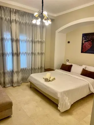 a bedroom with a large white bed and a window at Y 140 wast golf heated private pool in Hurghada