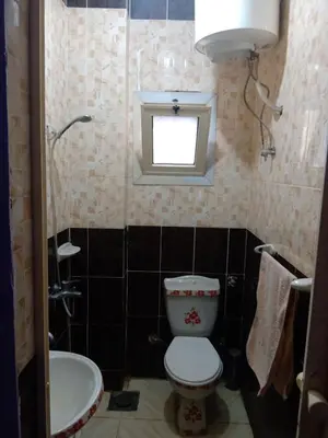 a small bathroom with a toilet and a sink at App11- BELAL - Enjoy the privacy of staying in a quiet apartment with free Wi-Fi as your complete second home in the heart of Hurghada in Hurghada