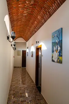 a hallway with a tile floor and a wooden ceiling at NUB INN in Aswan