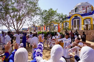 a group of people praying in front of a building at Artika Wadi Kiki Hotel in Aswan