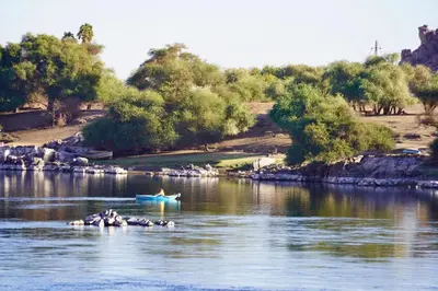 a person in a boat on a river at Artika Wadi Kiki Hotel in Aswan