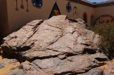 a large rock sitting in front of a building at Artika Wadi Kiki Hotel in Aswan