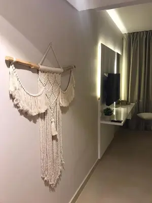 a necklace hanging on a wall next to a television at Jutta Deluxe 2,5-Bedroom-Apartment Mangroovy-M10 El Gouna in Hurghada