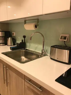 a kitchen with a sink and a counter top at Jutta Deluxe 2,5-Bedroom-Apartment Mangroovy-M10 El Gouna in Hurghada