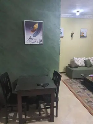 a living room with a table and a couch at Abeer suites 2 in Hurghada