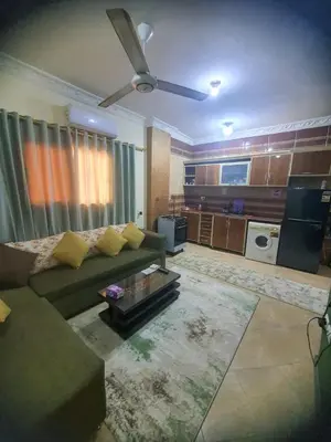 a living room with a couch and a ceiling fan at Abeer suites 2 in Hurghada