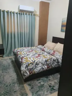 a bedroom with a bed with a colorful comforter at Abeer suites 2 in Hurghada