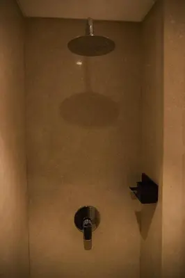 a bathroom with a shower with a light and a fan at Mangroovy apartament El gouna in Hurghada
