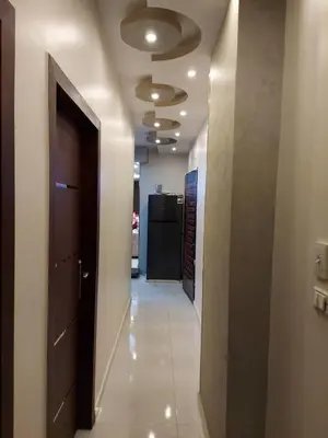 a hallway with a door and a refrigerator at شقة فندقية على البحر in Hurghada