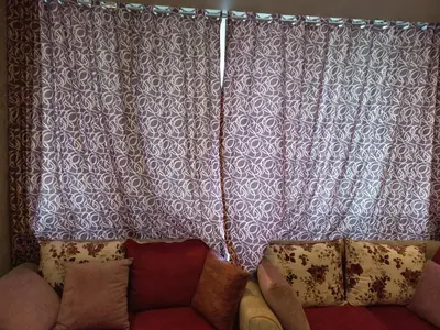 a couch sitting in front of a window with a curtain at شقة فندقية على البحر in Hurghada