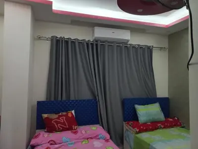 a room with two beds and a curtain at شقة فندقية على البحر in Hurghada