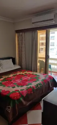 a bedroom with a bed with a flower blanket on it at 2bedroom apartment in Summer Land Beach Resort in Hurghada