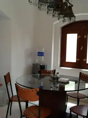 a dining room with a table and chairs and a kitchen at Gorgeous Villa in Gouna with Heated Private Pool in Hurghada