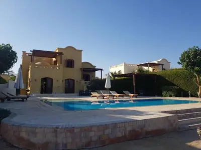a villa with a swimming pool and a house at Gorgeous Villa in Gouna with Heated Private Pool in Hurghada
