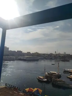 a view of a river with boats in the water at Mostafa Jamaica guesthouse in Aswan