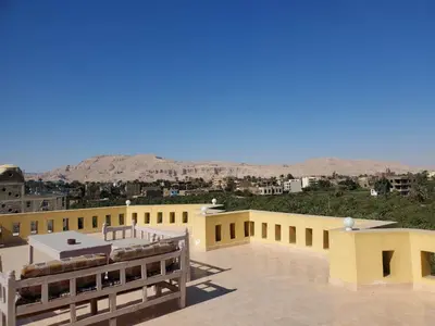 a yellow building with a view of the desert at Egypt Villa Garden in Luxor