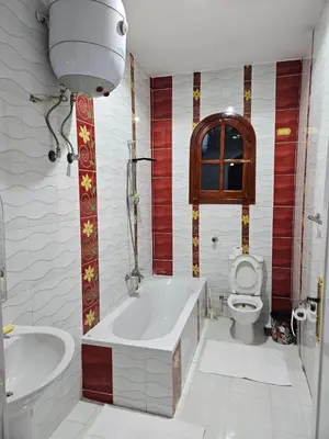 a bathroom with a tub and a toilet at Egypt Villa Garden in Luxor