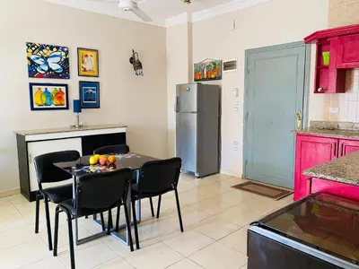 a kitchen with a table with chairs and a refrigerator at RITA HOUSE SEA VIEW. Hurghada center in Hurghada